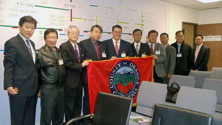 Supervisor Nelson presents the Korean American Sports Association of Orange County with an offical Orange County Flag