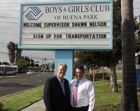 Supervisor Nelson and Bruce Hird under the Boys and Girls Club sign