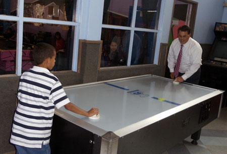 Supervisor Nelson took a moment to play a competitive air hockey game with one of the boys at the center.