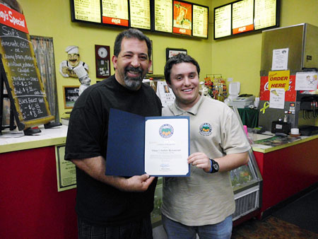 Nick Constantino presents the certificate for Restaurant of the Week to Vinny, owner of Vinny's Italian Restaurant.